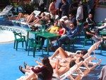 girls tanning next to the pool